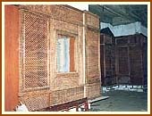 The Mandir interior shows an intricately carved wooden wall structure