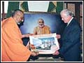 Pujya Atmaswarup Swami presents mementoes to the President