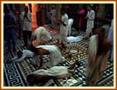 Saints and devotees prostrating after Mangala Arti