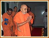 Swamishri emerges from 
his room and warmly greets the sadhus and devotees with folded hands and affectionate Jai Swaminarayans