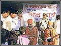 Sadhus distributing aid to the victims