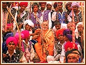 Tribal youths pose for a photograph with Swamishri 