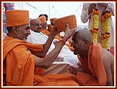 The    senior sadhus give a new kanthi, gatariyu (upper garment) and pagh (turban) to the newly initiated sadhus