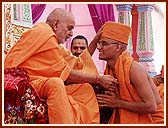 Finally, Swamishri crowns the ceremony by applying Chandan and imparting the Diksha-mantra
