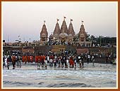 Saints and devotees on the sea shore just outside the Mandir
