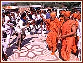 Tribal youth welcoming Swamishri with traditional music and dance