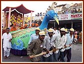 On the streets of Valsad the murtis of Shri Akshar Purushottam Maharaj, Shri Harikrishna Maharaj and Shri Ghanshyam Maharaj are paraded in a Peacock float, Swan float and Fish float respectively