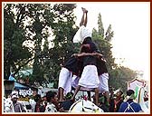 Exciting human pyramids during the procession by youth dancers, sadhus and tribal youths