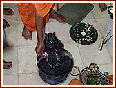 Performing Vedic worship (pujan) of Shivling, Shri Shiv-Parvati and Ganpatiji