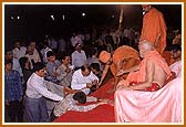 Devotees offering charity in a cloth bag (joli)