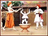 A colorful rustic stage depicting the celebration of Pushpadolotsav by Lord Swaminarayan with the paramhansas in the darbar of Rathod Dhadhal in Sarangpur     