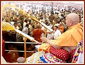 The crowning glory of the festival - Swamishri sprays the sanctified colored water on the elated devotees