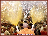 The crowning glory of the festival - Swamishri sprays the sanctified colored water on the elated devotees