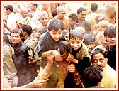 Flushed in a spray of colored water, the devotees ecstatically relish the ultimate moments of the festival