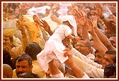 Flushed in a spray of colored water, the devotees ecstatically relish the ultimate moments of the festival