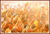Flushed in a spray of colored water, the devotees ecstatically relish the ultimate moments of the festival