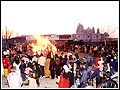The public circumambulate the Holi fire