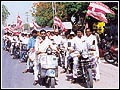 A Mahamantra Rally being  led by a cavalcade of motorists.