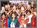 Young girls participate by carrying the auspicious kalashas.