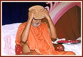 Swamishri devoutedly touches the chadar, to his eyes and head, that Shastriji Mahraj had covered on him as a mark of his appointment as president