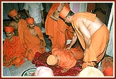 Swamishri prostrates with reverence and humility before the Gurus' murtis
