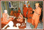 Swamishri stands with reverence before the murti of Shastriji Maharaj in the very small room where he was appointed as president