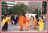 BAPS volunteers traditionally welcoming Hindu saints by showering petals