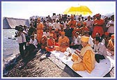 Swamishri with Lord Harikrishna Maharaj at the Sardar Sarovar site by the river Narmada. Swamishri prays for the early completion of the project