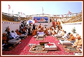 Doing pujan of the shlas (stones) symbolizing the gods of earth with rice grains, kumkum and flowers