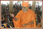 Swamishri blesses the devotees by showering rice grains