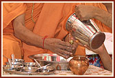 Ritually bathing Lord Harikrishna Maharaj with Panchamrut during the yagna 
