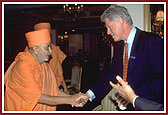 Pramukh Swami Maharaj and President Clinton greet each other warmly