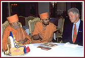 President Clinton listens with great interest to details of the life and work of Lord Swaminarayan