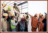 Essentials being distributed by volunteers and sadhus