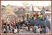 Essentials being distributed by volunteers and sadhus