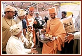 Essentials being distributed by volunteers and sadhus at BAPS Base Camp at Bhuj 
