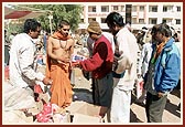 Essentials being distributed by volunteers and sadhus at BAPS Base Camp at Bhuj 