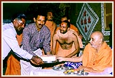 Swamishri presents the foundation bricks to leaders of the villages