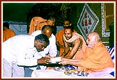 Swamishri presents the foundation bricks to leaders of the villages