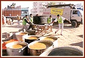 Hot meal being prepared and arranged for distribution 