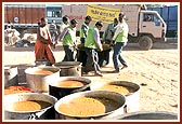 Hot meal being prepared and arranged for distribution 