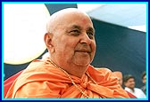 Swamishri in a radiant and humble mood while blessing the devotees as they file past