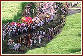 The Nagar Yatra moves through lush green sugarcane fields 