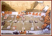 Swamishri and sadhus in the foundation pit for the shilanyas pujan