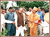 Purushottamcharan Swami welcomes the Governor by applying a chandlo