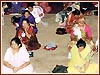 Ladies receive training on how to perform their personal morning puja