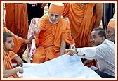 Swamishri is informed about the plans regarding the construction from the ground level