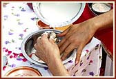 Swamishri ceremoniously bathes Shri Harikrishna Maharaj in panchamrut during the rituals