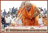 As a ritual of auspiciousness P. Ishwarcharan Swami splits the coconut on the first stone