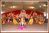 Children performing a colorful cultural dance during the Guru Punam assembly